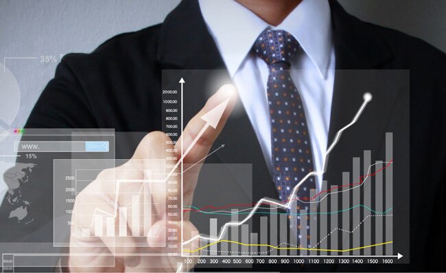 businessman with financial symbols coming from hand
